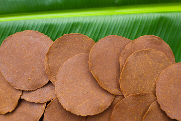 Sun-dried fermented soybean sheets called “Thua Nao,” a traditional ingredient in Northern Thai...