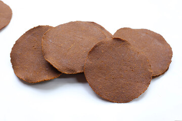 Fermented soybean discs, known as “Thua Nao,” a traditional Thai seasoning used to enhance flavor in Northern cuisine.