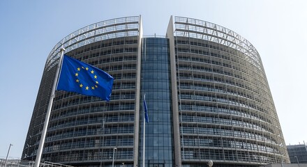 Modern glass building with EU flag waving in front. Headquarters of European Commission symbolizing governance, unity, and politics in the European Union.