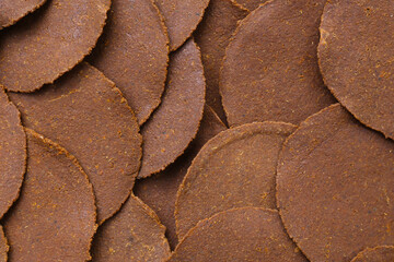 Fermented soybean discs, known as “Thua Nao,” a traditional Thai seasoning used to enhance...