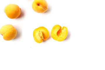 Fresh ripe apricots on a white background.