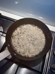 Deep frying shallot on the pan.