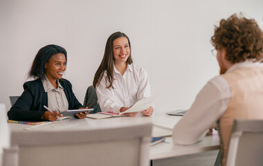 A team meeting with diverse participants collaboratively discussing key ideas in a modern workspace