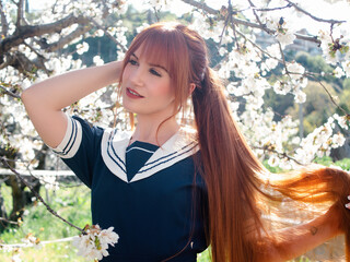 Cherry Trees in Bloom With Redhead Posing Gracefully Under the Blossoms