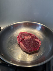A piece of steak on the pan.