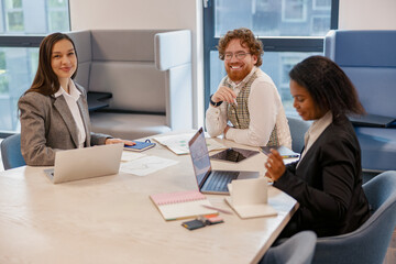 A dynamic and diverse team actively collaborating on an exciting project in a stylish and modern...