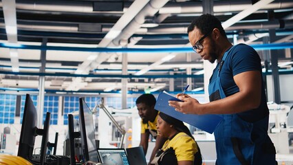 Supervisor in solar panel factory investigating potential malfunctioning systems, reading paperwork...