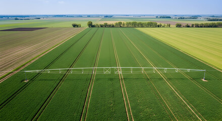 Aerial View Of Agricultural Irrigation System Spanning Across Green Fields