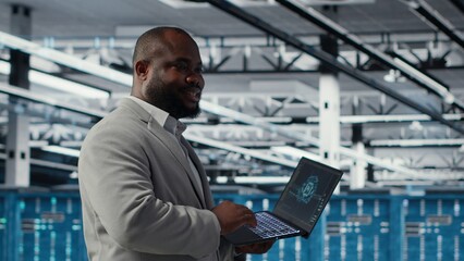 Smiling data center technician installing and upgrading hardware components. Happy server farm employee doing job tasks, implementing backup solutions to protect against data loss, camera B