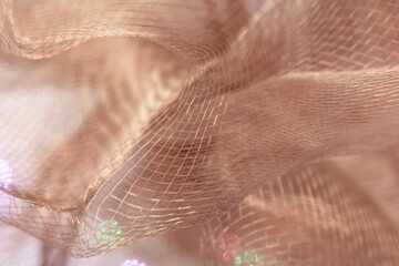 Delicate Translucent Mesh Fabric in Light Beige with Draped Folds and Intricate Line Patterns in...