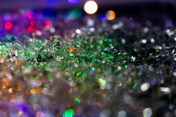 Colorful Iridescent Glass Pieces with Sparkling Bokeh – Close-Up of Crystal Textures in Green,...