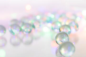 Translucent Iridescent Marbles on Smooth Surface – Dreamy Light Reflections and Bokeh Highlights...
