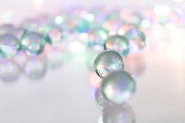 Close-Up of Translucent Marbles on White Surface – Colorful Reflections and Bokeh Effect for Play, Design, Branding, and Light-Inspired Visual Concepts