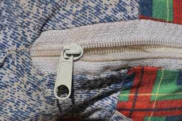 one white open metal plastic zip on color fabric clothes old jacket