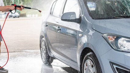Car washing. Car cleaning soap foam. Spray bubbles pressure wet shine.