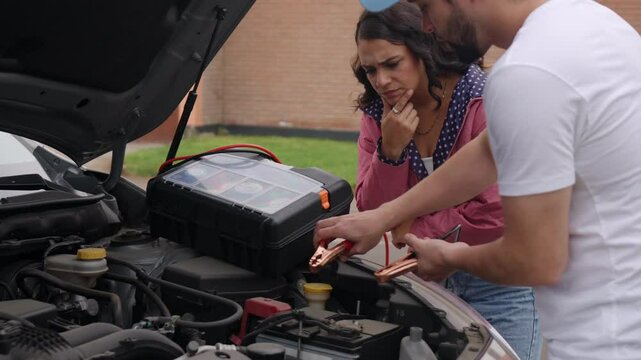 Couple struggling with car trouble during road trip