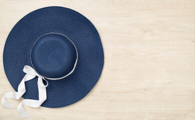 Blue beach hat on wooden background,top view
