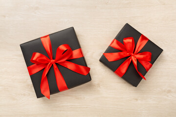 Black gift boxes on wooden background, top view. Black Friday concept
