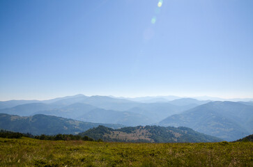 Breathtaking landscape depicting rolling green hills covered in dense forests against the backdrop...