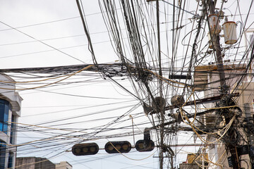 Chaotic overhead power lines and tangled cables for concepts of infrastructure problems, urban overload, or communication failure