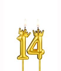 Golden number 14 birthday candle on white background