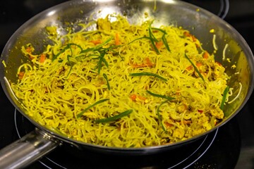 Traditional Asian food rice noodles known as bifum, with chicken, vegetables and curry