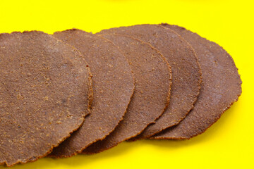 Sun-dried fermented soybean sheets called “Thua Nao,” a traditional ingredient in Northern Thai...