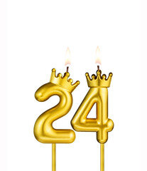 Golden number 24 birthday candle on white background
