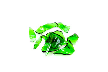 Sharp green glass shards scattered on a white background.