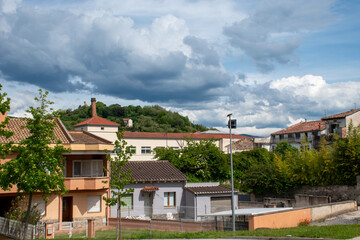 A cityscape with mountains of Olot, the capital city of the comarca of Garrotxa, in the Province of Girona, Catalonia, Spain