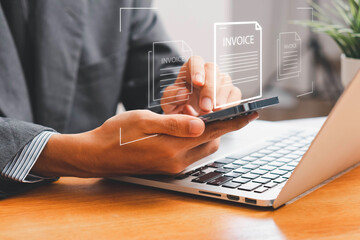 E-Invoice and Digital billing concept, Invoice, Businessman using laptop to manage electronic statements virtual screen. E-tax, Digital receipt, Online invoice processing and tax accounting solutions.