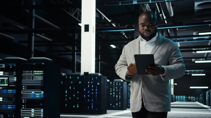 Server room admin doing troubleshooting to prevent downtime. IT specialist in data center reviewing reports and files, crosschecking network performance metrics and security logs, camera A - Powered by Adobe