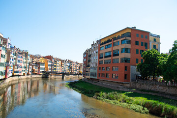 A cityscape view with beautiful residential buildings across the Onyar river in Girona, Catalonia, Spain.
