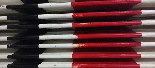 Stack of Red White Black Safety Delineator Posts