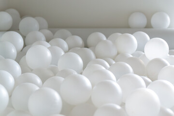 White Plastic Balls in Minimalist Play Area – Close-Up View