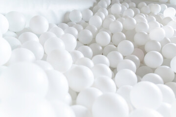 Diagonal Perspective of White Plastic Balls in Minimalist Play Zone. white balls pattern...