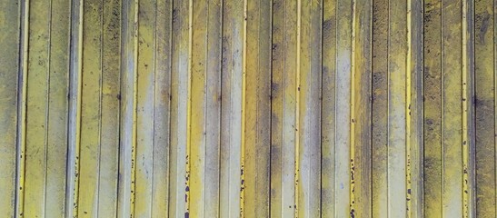 Weathered Vertical Yellow Stripes on Distressed Surface
