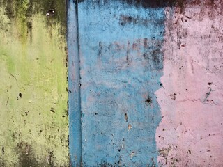 Weathered Wall with Faded Green Blue Pink Paint
