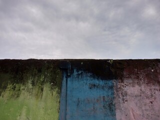 Weathered Wall with Faded Green Blue Pink Paint