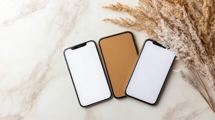 Three smartphones with blank screens elegantly arranged on a marble surface, representing modern technology and minimalistic design aesthetics.