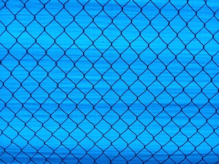 Fototapeta premium A simple, blue chain link wire fence background series. Perfect for digital designs, presentations and website backgrounds
