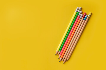 Group of pencils on yellow background. Top view
