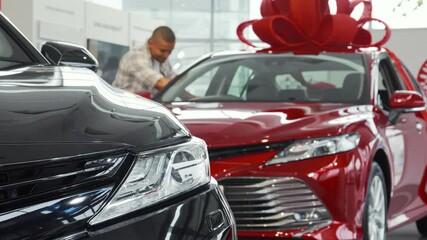 Young African man exploring options for his dream car