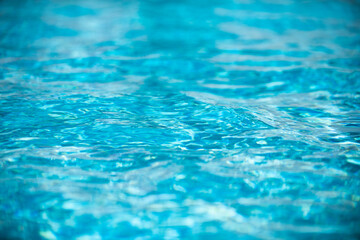 Ripple Water in swimming pool with sun reflection. Wavy water background.