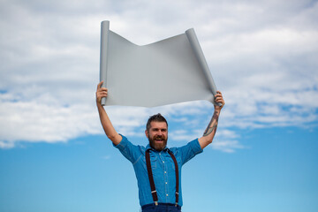 Funny man holding blank board. Hipster guy showing empty board. Guy with cardboard banner board....