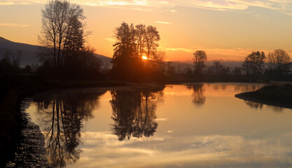 Romantic sunrise reflected in tranquil river