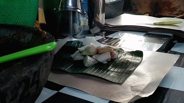 West Javanese street food "Kupat Tahu" is being made. Kupat Tahu consists of pieces of ketupat, tofu, sprinkled with bean sprouts and abundant of peanut sauce