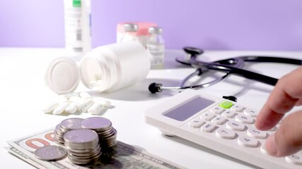 Footage shows a doctor calculating financial figures related to hospital income, patient billing, and insurance payments. Represents cost analysis and revenue tracking in the healthcare industry.

 - Powered by Adobe