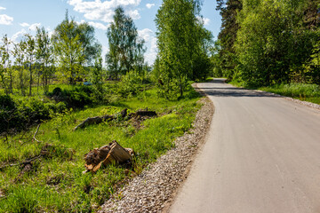 The shoulder of a country road covered with gravel, fresh asphalt on a country road