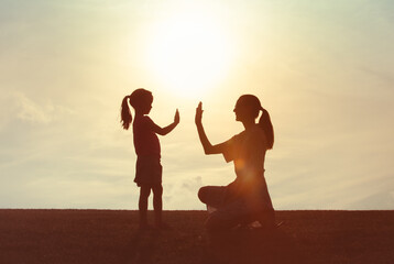 Mother giving daughter high five. Parent child relationship concept. Family support, childhood, ...